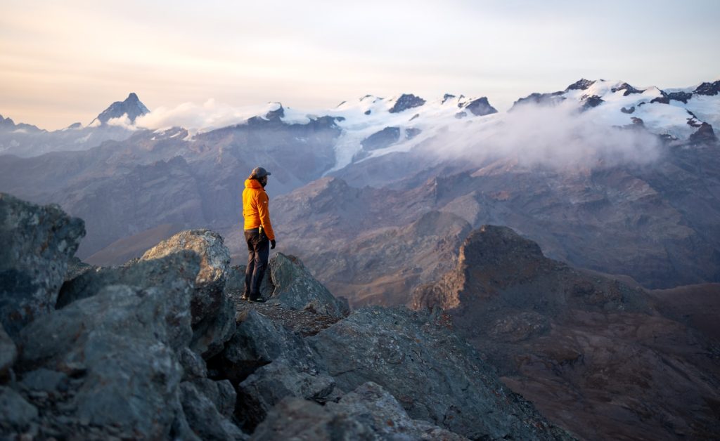 Hiker enjoys mountain view in the early morning.